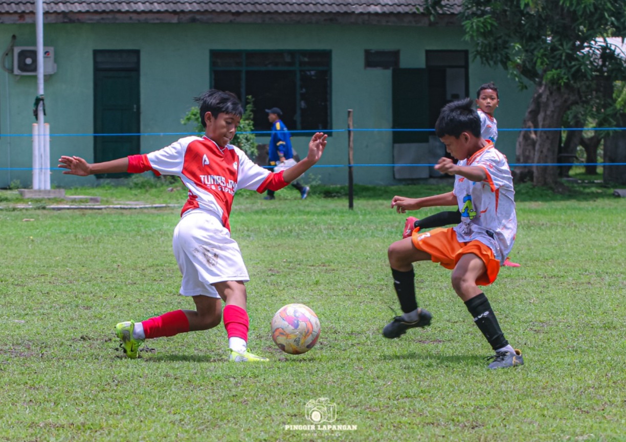 Penyerang SSB Tunas Jaya Sepande Beben (kiri) mencoba melewati pemain Talenta dalam pertandingan Piala Askab 2025 U-12 di Lapangan Panser.